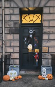 Black door with hanging skeleton and Boo and Eeek signs.