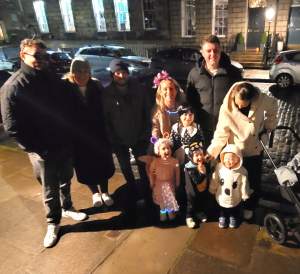 Group of adults and children out guising.