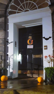 Black door with hanging bats either side.