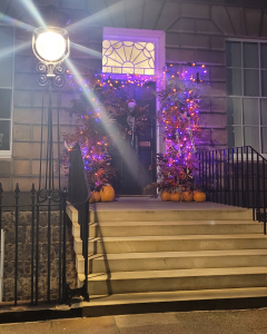 Door and steps up to a purple surround with a starry lamp shining.